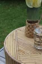 Bambù side table with natural bamboo inlay on a patio setting
