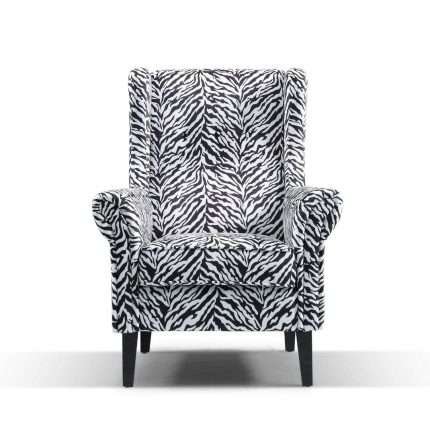 Bliss Wing Chair upholstered in zebra velvet with dark timber legs.