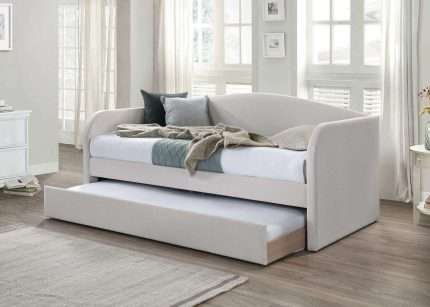 Charlotte day bed with trundle and natural fabric in cozy room.