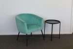Crewe Accent Chair in Aruba Blue velvet next to a small table