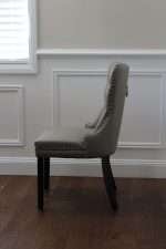 Side view of Elena chair in grey faux leather with tufted back
