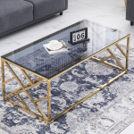 Luna Gold Coffee Table with glass top on a blue patterned rug in living room