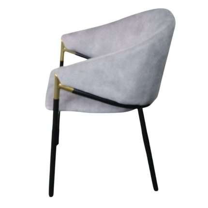 Manhattan Chair in light grey velvet with gold accents and black legs.